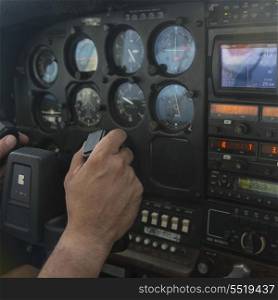 Closeup of a person&rsquo;s hand at control panel of a seaplane, Bay Islands, Honduras