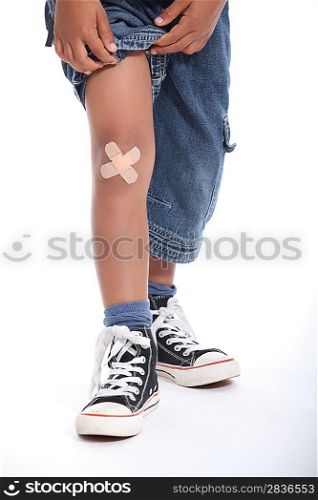 Closeup of a plaster on a little boy&acute;s knee