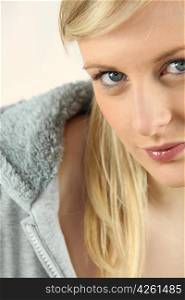 Closeup of a pretty blonde in a grey hoody