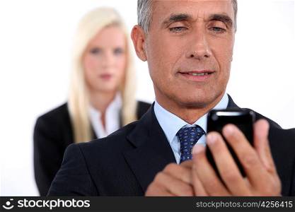 Closeup of a senior businessman using mobile phone
