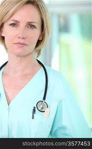Closeup of a serious female medic in scrubs