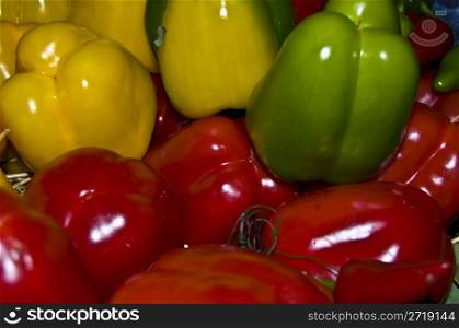 closeup of a stack of yellow, red and green bellpeppers
