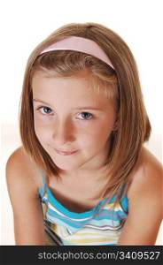 Closeup of a very pretty young girl with blond hair, looking into thethe camera, on white background.