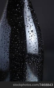 Closeup of a wet champagne bottle