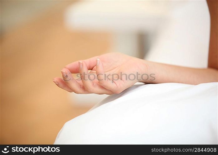Closeup of a woman&acute;s hand on a bed