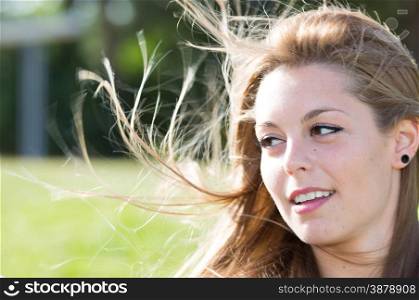 Closeup of a woman in a park with defocused