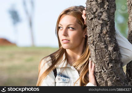 Closeup of a woman in a park with defocused