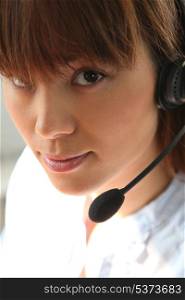 Closeup of a woman wearing a telephone headset