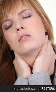 Closeup of a woman with a neckache