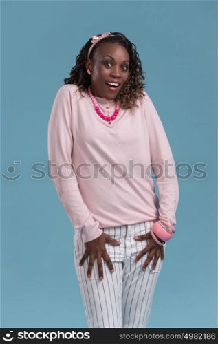 Closeup of a young African woman looking surprised on blue background