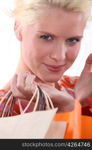 Closeup of a young blond woman carrying shopping bags