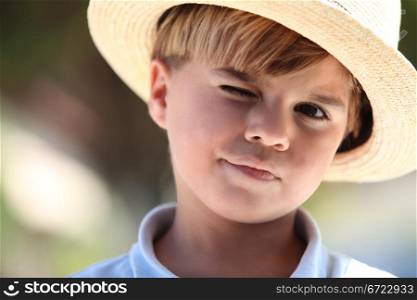 Closeup of a young boy in a straw hat