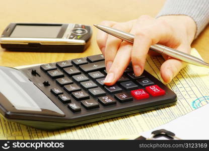 Closeup of a young women calculating bills
