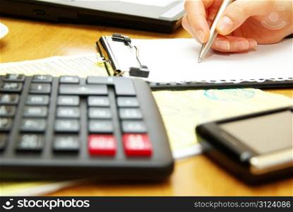 Closeup of a young women calculating bills