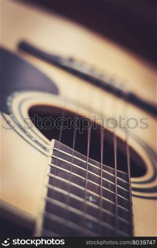 Closeup of acoustic guitar with shallow depth of field