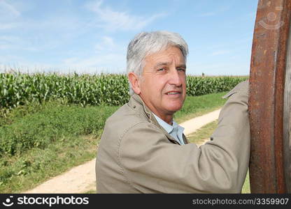 Closeup of agronomist in front of corn field