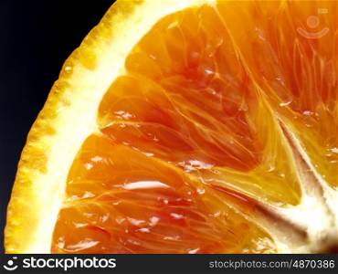 closeup of an orange with black background. orange