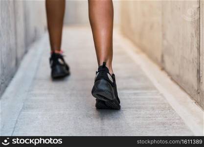Closeup of athlete woman running and doing exercise outdoors. Sport and healthy lifestyle.