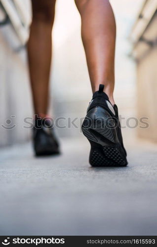 Closeup of athlete woman running and doing exercise outdoors. Sport and healthy lifestyle.