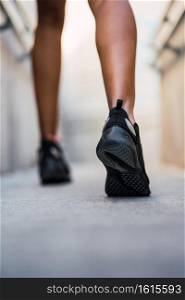 Closeup of athlete woman running and doing exercise outdoors. Sport and healthy lifestyle.
