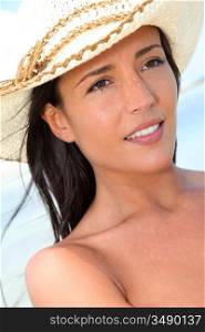 Closeup of attractive woman wearing hat at the beach