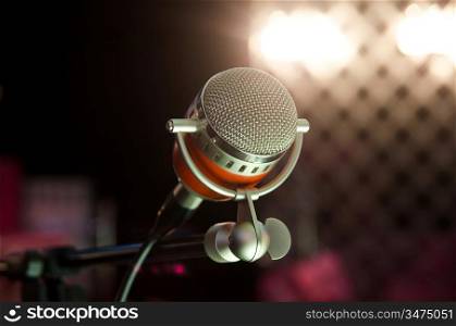Closeup of audio microphone on stage background