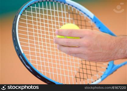 Closeup of ball and tennis racket