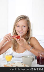Closeup of beautiful blond girl having breakfast