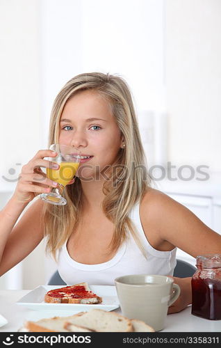 Closeup of beautiful blond girl having breakfast