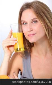 Closeup of beautiful blond woman drinking fruit juice