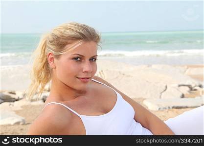 Closeup of beautiful blond woman relaxing by the beach