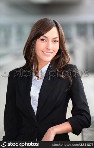 Closeup of beautiful businesswoman standing outside the office