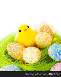 Closeup of beautiful Easter still life isolated on white background, colorful eggs on green grass, nice yellow chick, traditional Christian holiday