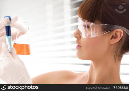 closeup of beautiful lab worker holding up test tubes