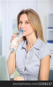 Closeup of beautiful office worker drinking water