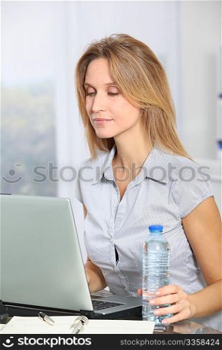 Closeup of beautiful office worker drinking water