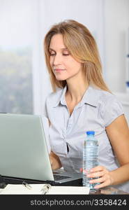 Closeup of beautiful office worker drinking water