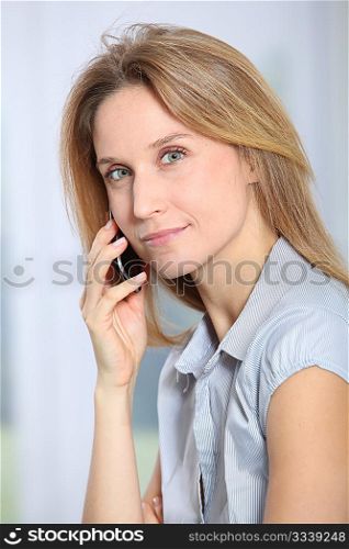 Closeup of beautiful office worker talking on the phone