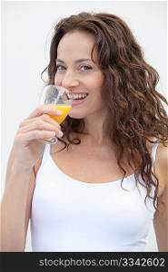 Closeup of beautiful woman drinking orange juice