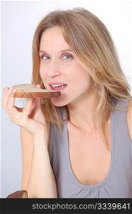 Closeup of beautiful woman eating slice of bread