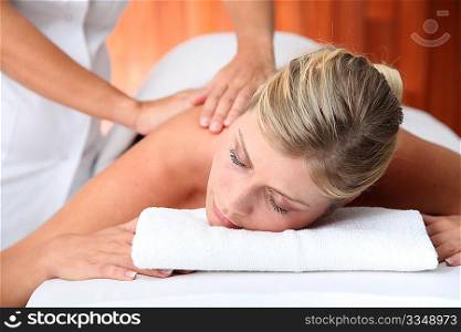 Closeup of beautiful woman laying on a massage bed