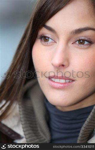 Closeup of beautiful woman with warm jacket in winter