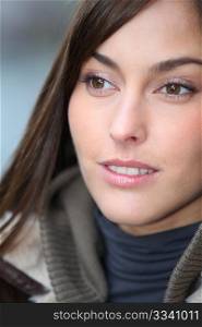 Closeup of beautiful woman with warm jacket in winter