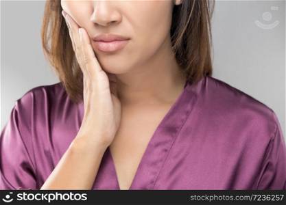 Closeup of beautiful young woman suffering from toothache, Dental health and care, People with teeth problem concept.