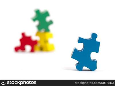 Closeup of big jigsaw puzzle piece isolated on white, perspective