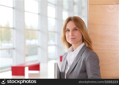 Closeup of blond businesswoman standing in hall