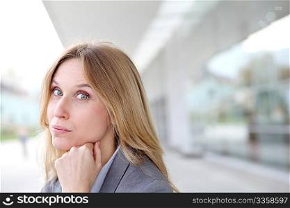 Closeup of blond businesswoman standing outside
