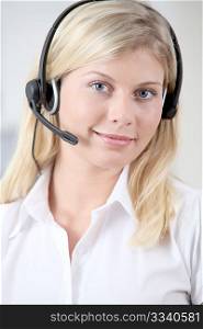 Closeup of blond woman with headphones and microphone