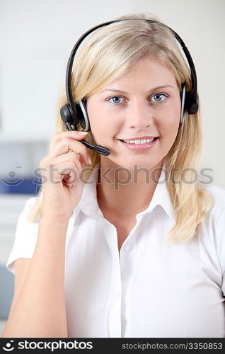 Closeup of blond woman with headphones and microphone