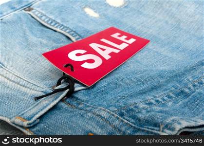 Closeup of Blue Jeans With Red Sale Tag - Shallow Depth of Field